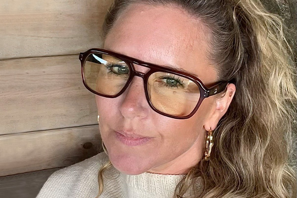 Bianca modelling a pair of oversized glasses with yellow-tinted lenses.